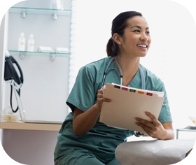 Nurse smiling while holding patient chart