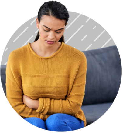 Woman with ulcerative colitis grabbing abdomen in pain