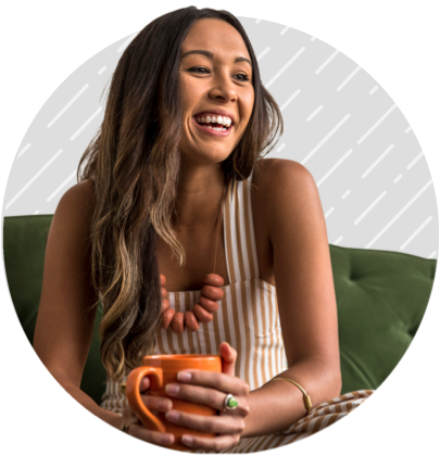 Woman smiling holding a coffee mug